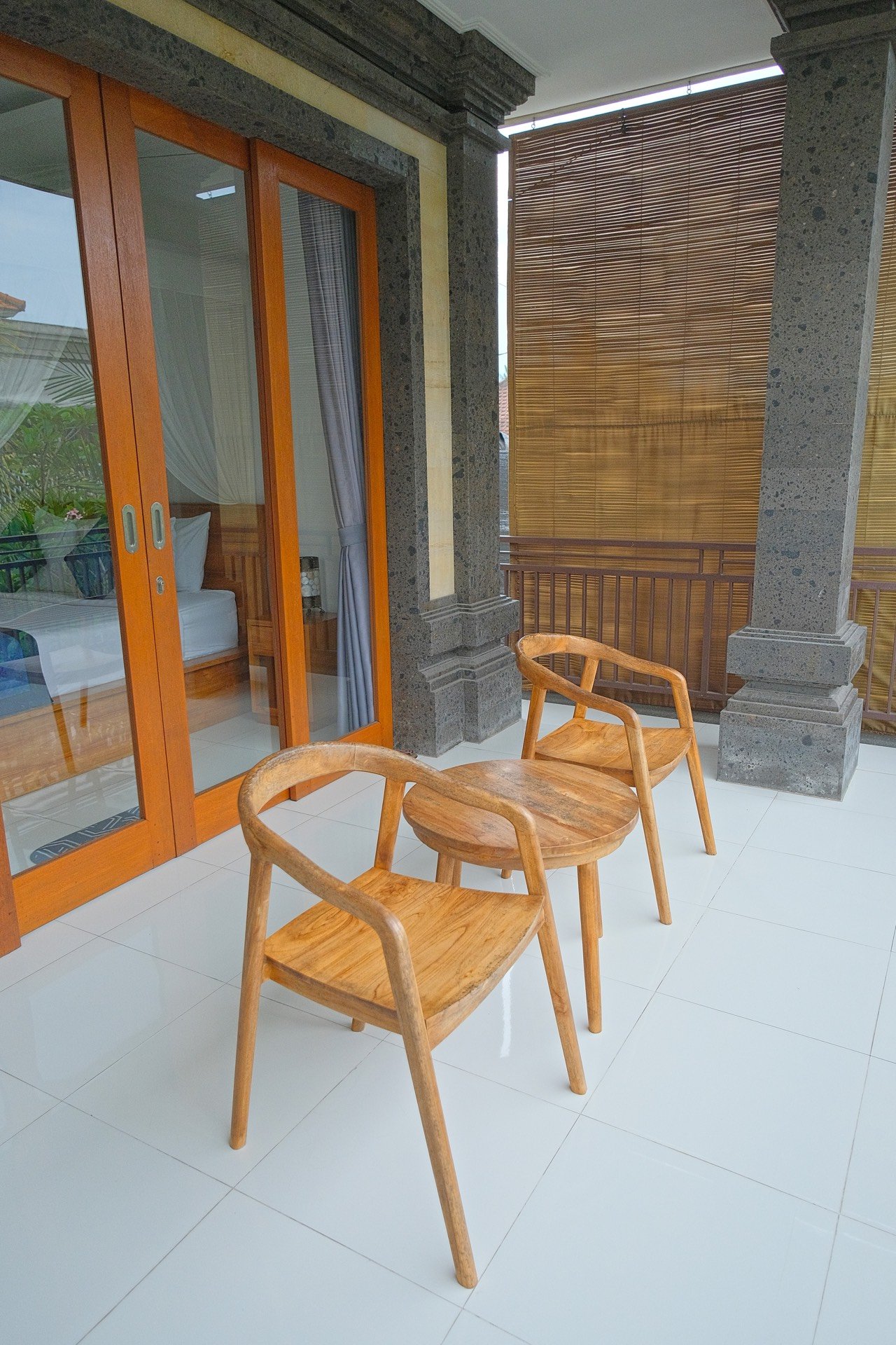 Cahyana House bedroom terrace with teak chairs