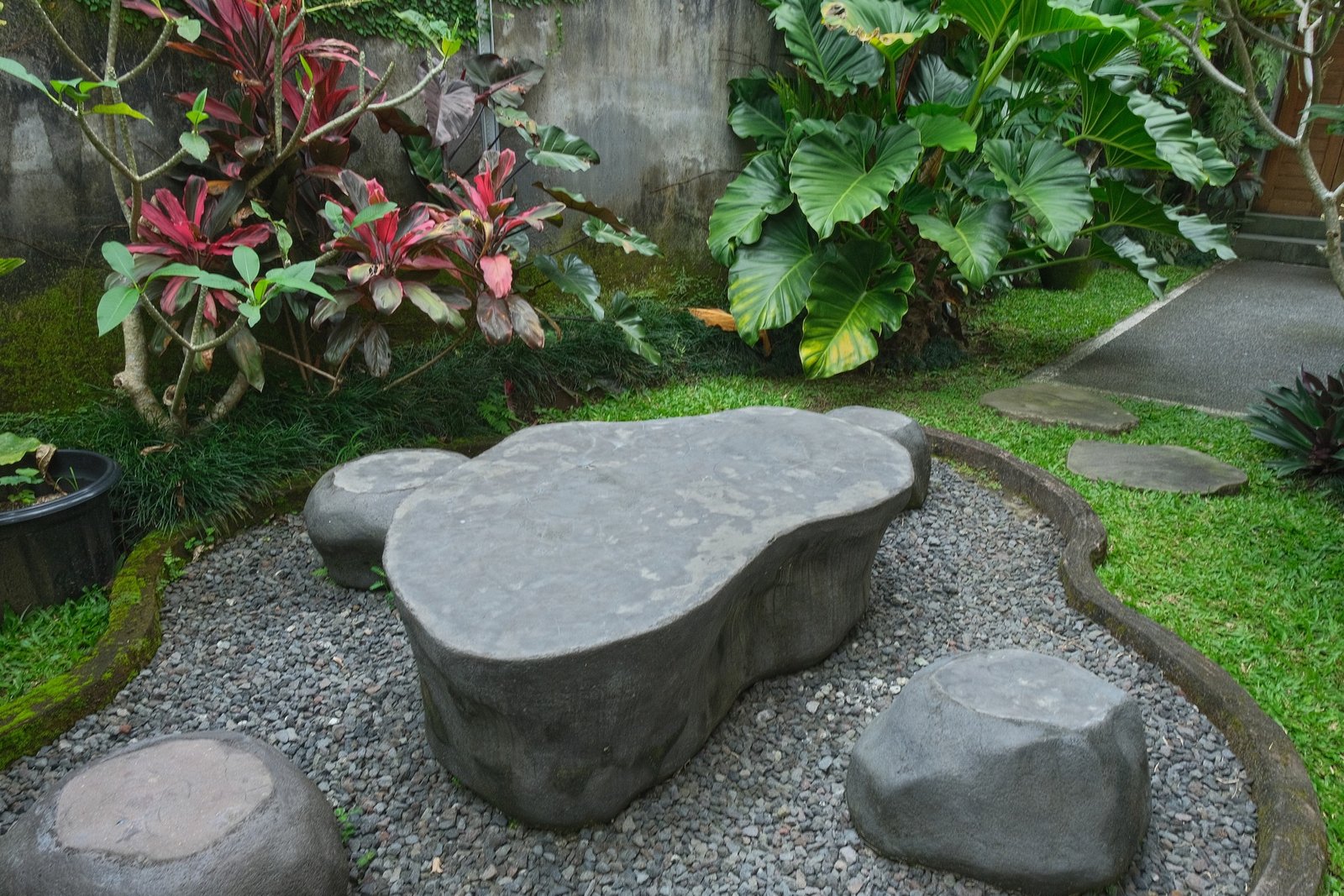 Cahyana House garden with a stone table