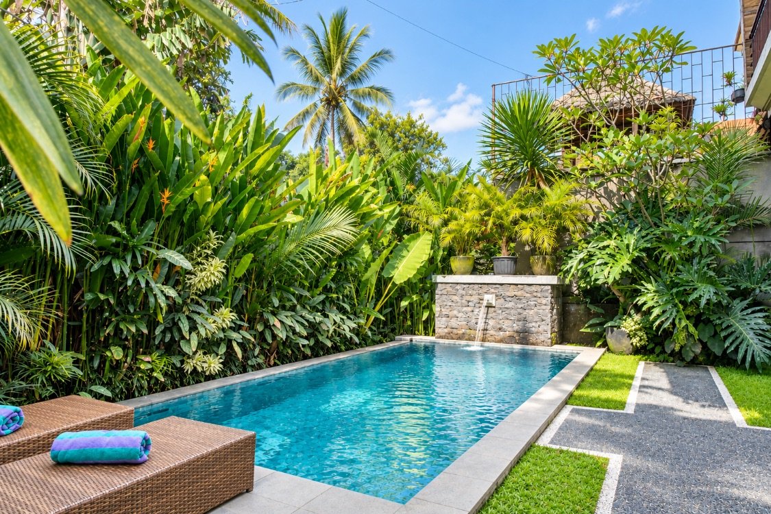Cahyana House private pool with a stone water feature and tropical garden