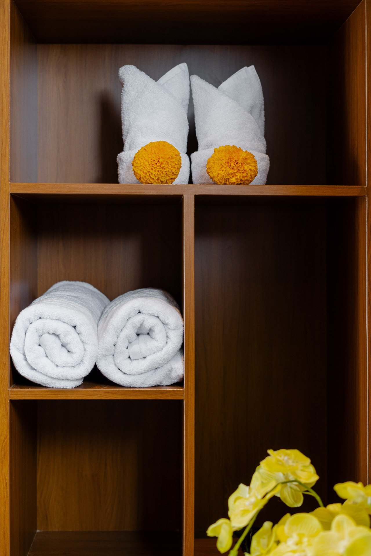 Cahyana Tibuah - folded towels on the bathroom shelf (1)