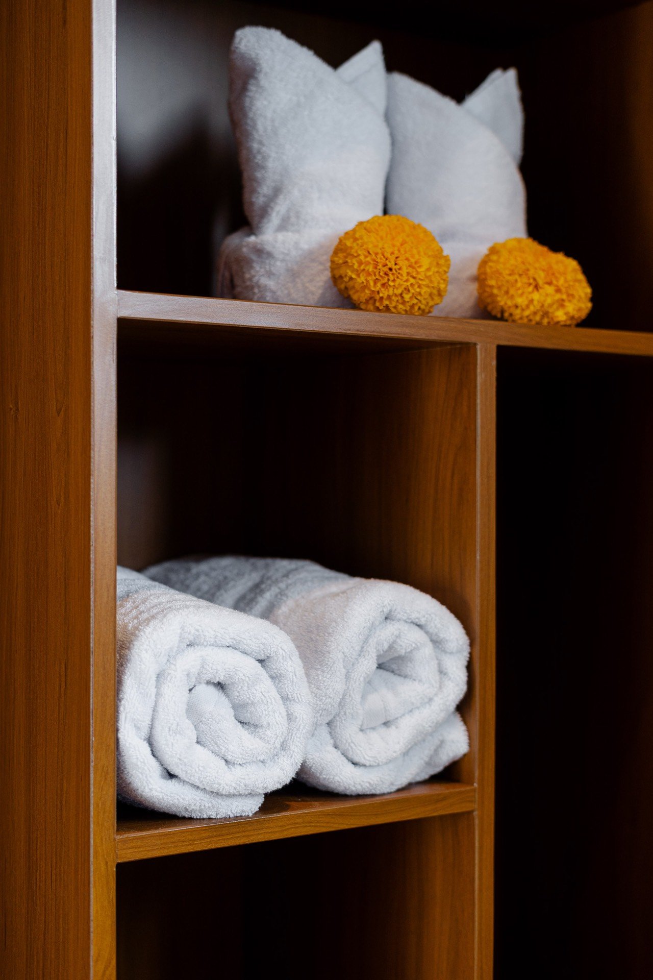 Cahyana Tibuah - folded towels on the bathroom shelf (2)