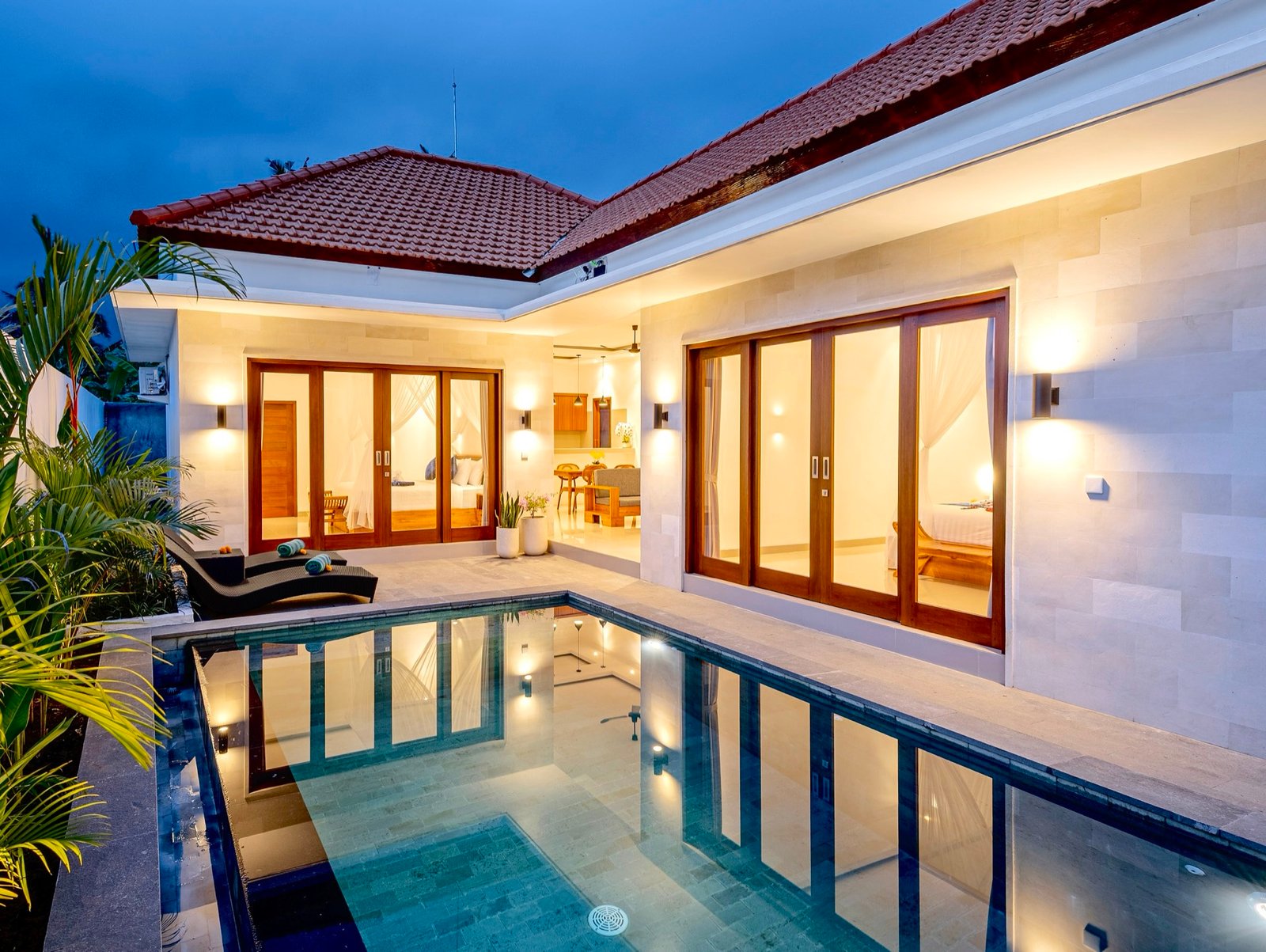 Cahyana Tibuah - the villa lit at dusk above the pool