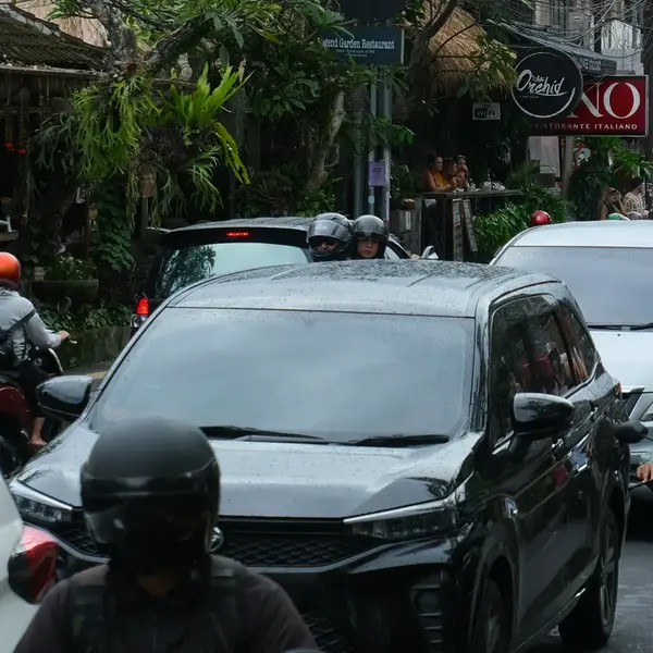 Scooters and cars on a busy road in Ubud